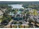Aerial view of a community pool, splashpad, and recreation center surrounded by lush landscaping at 12468 Shimmering Oak Cir, Venice, FL 34293