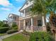 This charming home boasts double porches, a well-kept lawn, and mature palm trees at 12468 Shimmering Oak Cir, Venice, FL 34293