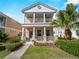 Charming home with a double porch, a well-maintained lawn, and lush landscaping at 12468 Shimmering Oak Cir, Venice, FL 34293