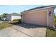 Attached garage with concrete driveway and well-maintained lawn offer convenience and curb appeal at 12468 Shimmering Oak Cir, Venice, FL 34293