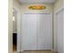 Hallway view featuring closet doors with overhead 'Sammy's Surf Shack' sign at 12468 Shimmering Oak Cir, Venice, FL 34293
