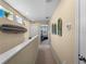 Hallway with stairway and walls decorated with ocean themed decoration pieces and small windows at 12468 Shimmering Oak Cir, Venice, FL 34293