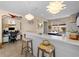 Kitchen with a breakfast bar, pendant lighting, and a view to the outside at 12468 Shimmering Oak Cir, Venice, FL 34293