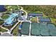 This aerial view highlights community amenities: a pool, tennis courts, and pickleball courts at 12580 Galapagos Ct # 107, Venice, FL 34293
