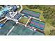 Aerial view showcasing the clubhouse, tennis and pickleball courts at 12580 Galapagos Ct # 107, Venice, FL 34293