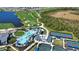 An aerial view displays a community pool, golf course, and pickleball courts at 12580 Galapagos Ct # 107, Venice, FL 34293
