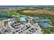 Aerial view shows community pool, golf course, tennis courts, parking, and clubhouse at 12580 Galapagos Ct # 107, Venice, FL 34293
