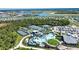 An aerial view showcases the community pool, tennis courts, and surrounding homes and landscape at 12580 Galapagos Ct # 107, Venice, FL 34293