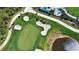 Aerial view of a golf course with sand traps and a lake at 12580 Galapagos Ct # 107, Venice, FL 34293