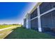 Exterior of condos with screened-in lanais and a view of the golf course on a bright sunny day at 12580 Galapagos Ct # 107, Venice, FL 34293