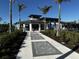 Exterior of clubhouse and landscaped walkway at 12580 Galapagos Ct # 107, Venice, FL 34293