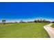 View of a beautifully manicured golf course on a bright sunny day with condos in the background at 12580 Galapagos Ct # 107, Venice, FL 34293