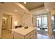 Bright kitchen with white island, sleek appliances, and convenient access to the outdoor patio for easy living at 12580 Galapagos Ct # 107, Venice, FL 34293