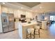 Bright kitchen featuring white cabinetry, stainless steel appliances, a spacious island, and modern fixtures at 12580 Galapagos Ct # 107, Venice, FL 34293