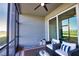 Relaxing screened-in lanai with comfortable seating, ceiling fan, and a peaceful view of the golf course at 12580 Galapagos Ct # 107, Venice, FL 34293
