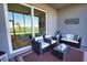 Screened-in lanai with comfortable seating, coffee table, outdoor rug, and a view of the golf course at 12580 Galapagos Ct # 107, Venice, FL 34293