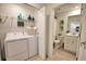 Well-lit laundry room with a washer, dryer, and view of the bathroom beyond at 12580 Galapagos Ct # 107, Venice, FL 34293