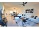 Bright living room featuring a white sectional sofa, modern art, and an open floor plan at 12580 Galapagos Ct # 107, Venice, FL 34293