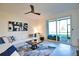 Cozy living room with a large sectional sofa, abstract art, and sliding glass doors to the patio at 12580 Galapagos Ct # 107, Venice, FL 34293