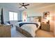 Comfortable main bedroom with a king bed, soft lighting, and neutral decor at 12580 Galapagos Ct # 107, Venice, FL 34293