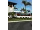 Wellen Park Golf & Country Club sign with lush landscaping and palm trees on a bright sunny day at 12580 Galapagos Ct # 107, Venice, FL 34293