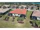 Beautiful aerial view of a home with a terracotta roof and screened lanais surrounded by lush landscaping at 12744 Oriago St, Venice, FL 34293