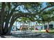 Community outdoor seating area with tables, mature tree canopies, and Waterside Place food trucks at 12744 Oriago St, Venice, FL 34293