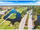 Aerial view of a golf course with charming bridges, ponds, and manicured greens at 1298 Highland Greens Dr, Venice, FL 34285