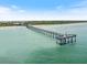 Aerial view of the Venice Fishing Pier stretching into the turquoise Gulf waters, a picturesque fishing destination at 1298 Highland Greens Dr, Venice, FL 34285