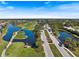Aerial view of the Pelican Point community showing the lush landscaping, water features and surrounding golf course at 1298 Highland Greens Dr, Venice, FL 34285