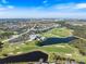 Stunning aerial shot overlooking the golf course, lush greenery and beautiful homes in this vibrant community at 1298 Highland Greens Dr, Venice, FL 34285