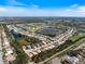 Panoramic aerial shot of the residential area featuring stunning water views at 1298 Highland Greens Dr, Venice, FL 34285