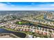 Beautiful aerial view of the community with lakes, golf course, and well-manicured lawns at 1298 Highland Greens Dr, Venice, FL 34285