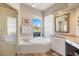 Bathroom with a soaking tub, glass-enclosed shower, and granite vanity with ample counter space at 1298 Highland Greens Dr, Venice, FL 34285