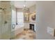 Elegant bathroom featuring a glass-enclosed shower, a soaking tub, and a stylish vanity area at 1298 Highland Greens Dr, Venice, FL 34285