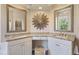 Beautiful bathroom vanity with dual sinks, granite countertops, and decorative mirrors at 1298 Highland Greens Dr, Venice, FL 34285