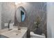 Stylish bathroom with designer wallpaper, a modern sink, and elegant fixtures at 1298 Highland Greens Dr, Venice, FL 34285