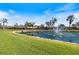 Pelican Pointe Golf & Country Club entrance with fountain and lush landscaping at 1298 Highland Greens Dr, Venice, FL 34285