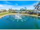 Welcome to Pelican Pointe Golf & Country Club, a beautiful community with lush landscaping and a serene water feature at 1298 Highland Greens Dr, Venice, FL 34285
