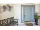 Welcoming front porch with a bench, potted plant, and a stylish front door at 1298 Highland Greens Dr, Venice, FL 34285