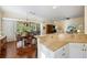 Granite countertop of the kitchen breakfast bar is viewed from the living and dining areas at 1298 Highland Greens Dr, Venice, FL 34285