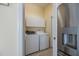Efficient laundry area featuring a modern washer, dryer, and convenient overhead cabinets for storage at 1298 Highland Greens Dr, Venice, FL 34285