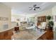 Inviting living room featuring hardwood floors, comfortable seating, and seamless flow to the dining area at 1298 Highland Greens Dr, Venice, FL 34285