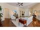Open-concept living room with hardwood floors, ceiling fan and seamless flow throughout the home at 1298 Highland Greens Dr, Venice, FL 34285