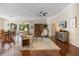 Spacious living room with hardwood floors, a ceiling fan, and a view of the outdoor patio at 1298 Highland Greens Dr, Venice, FL 34285