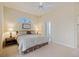 Bright and airy main bedroom with neutral tones, ceiling fan, and ensuite bathroom for a relaxing retreat at 1298 Highland Greens Dr, Venice, FL 34285