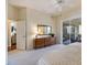 Spacious main bedroom featuring neutral tones, a ceiling fan, and a sliding door to the lanai at 1298 Highland Greens Dr, Venice, FL 34285