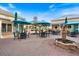 Charming outdoor patio with tables, chairs, fountain and umbrellas, perfect for relaxing and enjoying the beautiful weather at 1298 Highland Greens Dr, Venice, FL 34285