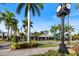 Charming street view featuring palm trees, blooming flowers, and classic architecture, showcasing the town's ambiance at 1298 Highland Greens Dr, Venice, FL 34285
