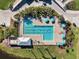 Aerial view of a fenced swimming pool with clear water, umbrellas, and lounge chairs at 1298 Highland Greens Dr, Venice, FL 34285